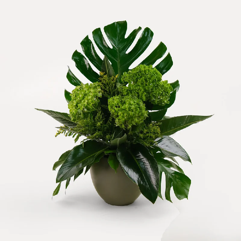 large crystal flower vase -Green hydrangea flower arrangement with Monstera swiss cheese leaves and palm leaves